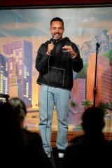 James Mwaura performing stand-up comedy on stage